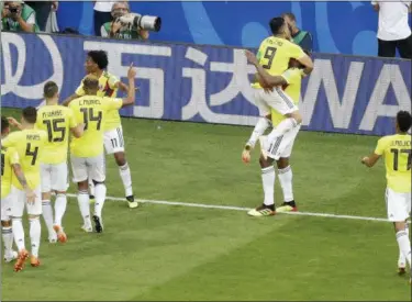  ?? GREGORIO BORGIA — THE ASSOCIATED PRESS ?? Colombia’s Yerry Mina, second from right, celebrates with his teammates after scoring his side’s first goal during the group H match between Senegal and Colombia, at the 2018 soccer World Cup in the Samara Arena in Samara, Russia, Thursday.