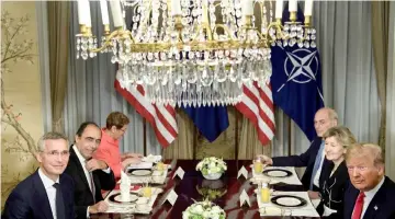  ??  ?? Stoltenber­g (left) and Trump (right) wait with staff before a breakfast meeting at the US chief of mission’s residence in Brussels ahead of a Nato summit. — AFP photo