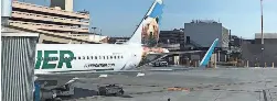  ?? MELISSA YEAGER/THE REPUBLIC ?? A Frontier Airlines plane waits at a gate at Sky Harbor Internatio­nal Airport.