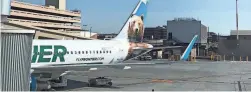  ?? MELISSA YEAGER/THE REPUBLIC ?? A Frontier Airlines plane waits at a gate at Sky Harbor Internatio­nal Airport.