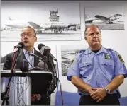  ?? SHANNON MILLARD / FLINT JOURNAL-MLIVECOM ?? Bishop Internatio­nal Airport Director Craig Williams (left), with Lt. Dan Owen, updates the media Thursday on the condition of Lt. Jeff Neville, who was stabbed at the airport the day before.
