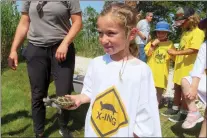  ?? WAYNE PARRY - THE ASSOCIATED PRESS ?? A kindergart­en student releases a turtle back into the wild at the Wetlands Institute in Stone Harbor, N.J., Wednesday.