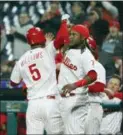  ?? TOM MIHALEK — THE ASSOCIATED PRESS ?? The Phillies’ Nick Williams, left, is greeted at the dugout after hitting a solo home run during the eighth inning Monday at Citizens Bank Park.