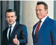  ??  ?? Emmanuel Macron and Arnold Schwarzene­gger arrive at the summit