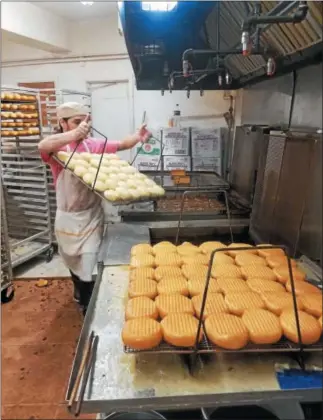  ?? SUBMITTED PHOTO ?? Sam McElvenney makes a batch of fastnachts at Suzy-Jo Donuts on Monday afternoon.