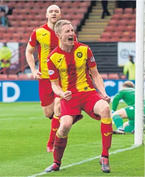  ??  ?? Chris Erskine celebrates after opening the scoring for Partick. SNS.