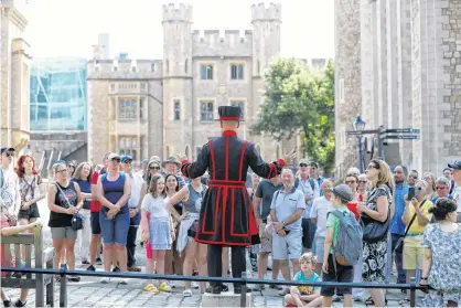  ?? REUTERS ?? A Yeoman Warder, Barney Chandler speaks to the group, as he leads the first “Beefeater” tour of the Tower of London in 16 months, at the Tower of London, Britain, on Monday.