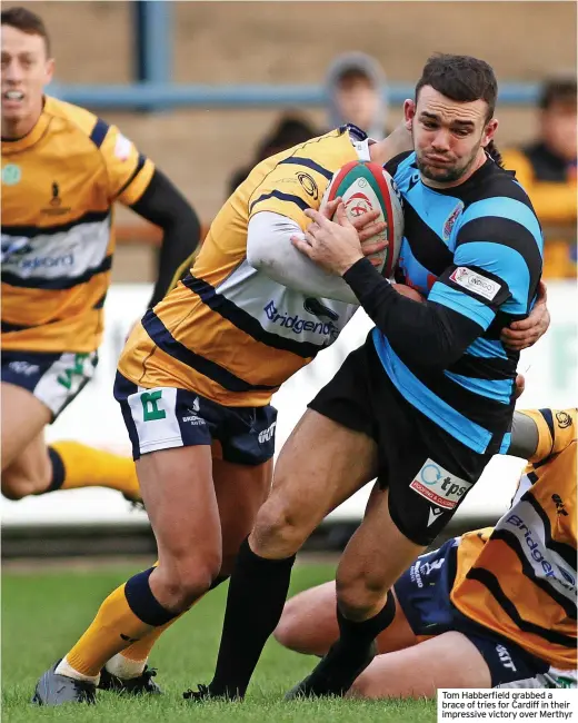  ?? ?? Tom Habberfiel­d grabbed a brace of tries for Cardiff in their impressive victory over Merthyr