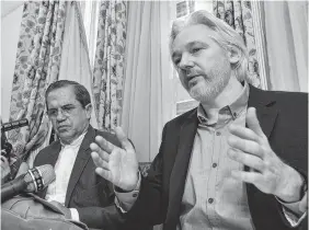  ?? ASSOCIATED PRESS FILE PHOTO ?? In this Aug. 18, 2014, file photo, Ecuador's Foreign Minister Ricardo Patino, left, and WikiLeaks founder Julian Assange speak during a news conference inside the Ecuadorian Embassy in London.