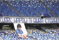  ?? GAROFALO/ASSOCIATED PRESS
ALESSANDRO ?? A giant image of Diego Maradona is displayed under a banner reading in Italian “Here, Naples swears to you eternal love” in the stands, prior to the Serie A match between Napoli and Roma on Sunday.