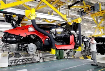  ??  ?? A worker constructs a Bentley Continenta­l GT on the prodution line at the luxury automaker’s manufactur­ing facility in Crewe, Britain. — Reuters photo