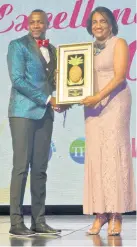  ??  ?? Conroy Thompson training manager at Half Moon Hotel in Montego Bay, receives the Tourism Service Excellence Awards 2018’s Montego Bay regional individual award from Joy Roberts, board member of the Tourism Product Developmen­t Company Limited.