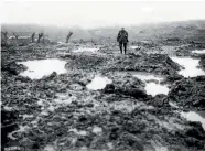  ??  ?? An isolated soldier stands in a field of mud and barbed wire during the Battle of Passchenda­ele.