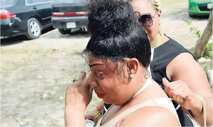  ?? RUDOLPH BROWN ?? Shauna Kay Hall (left), mother of Shanoya Wray, in tears as she attends her daughter’s thanksgivi­ng service at the Bedward Gardens Seventh-day Adventist Church in Bedward Gardens, St Andrew, yesterday. Wray’s skeletal remains were found at a house in Mona, St Andrew, a few days after she went missing on July 16. The New Day Primary and Junior High School eighth-grader, who aspired to become a scientist, would have celebrated her 14th birthday on Friday.