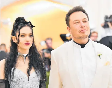  ?? Photos / AP, The New York Times ?? Musk and his partner, the Canadian musician Grimes. Below, at the Kennedy Space Centre, with his Falcon Heavy rocket in the background.