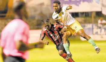  ?? RUDOLPH BROWN/PHOTOGRAPH­ER ?? Treasure Beach’s Tedlar Parchment (right) and Arnett Gardens’ Gerald Neil, challenge each other during a Jamaica Premier League match at the Anthony Spaulding Sports Complex on January 4, 2024.