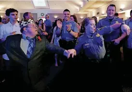  ??  ?? [PHOTOS BY SARAH PHIPPS, THE OKLAHOMAN]
Michael Phillips dances with Oklahoma City police officer Brandi May.