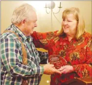  ?? Westside Eagle Observer/RANDY MOLL ?? Ron Dodd (left), receives a Volunteer of the Year Award from Janie Parks, executive director of the Gentry Chamber of Commerce, at an awards banquet on Thursday in Gentry.