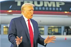  ?? ALEX BRANDON/THE ASSOCIATED PRESS ?? Former President Donald Trump speaks with reporters before departing from Hartsfield-Jackson Atlanta Internatio­nal Airport in Atlanta on Thursday. After Trump was booked Thursday evening, seven co-defendants who had not yet surrendere­d did so Friday morning.