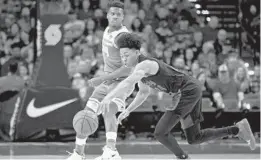  ?? CRAIG MITCHELLDY­ER/AP ?? Anfernee Simons of Portland reaches for a loose ball in front of Sacramento Kings guard Buddy Hield in an NBA game. Simons, a rookie, scored 37 points in a home-court win.