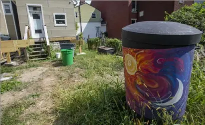  ?? Steph Chambers/Post-Gazette ?? A rain barrel used to help keep the Millvale Community Library garden watered.