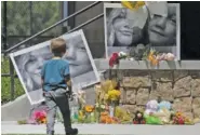  ?? JOHN ROARK/THE IDAHO POST-REGISTER VIA AP ?? A boy looks at a memorial for Tylee Ryan, 17, and Joshua “JJ” Vallow, 7, Thursday at Porter Park in Rexburg, Idaho,