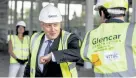  ?? Richard Pohle, The Times via The Associated Press ?? British Prime Minister Boris Johnson bumps elbows with scientists as he visits the constructi­on site of a new vaccine manufactur­ing center Friday near Didcot, England.