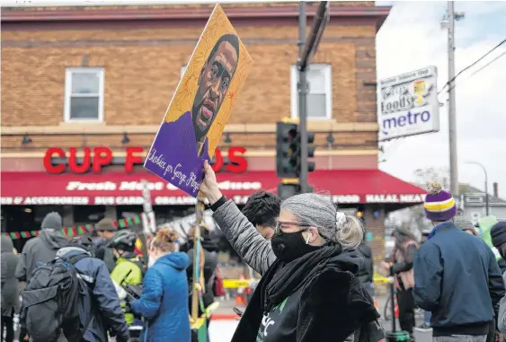  ?? ADREES LATIF • REUTERS ?? People wait for the announceme­nt of the verdict Tuesday in the trial of former Minneapoli­s police officer Derek Chauvin, who faced murder charges in the death of George Floyd, at the George Floyd Square in Minneapoli­s, Minn.