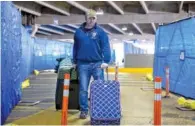  ?? ARVIN TEMKAR / ATLANTA JOURNAL-CONSTITION ?? A person walks Friday through constructi­on in the north parking deck by Hartsfield-Jackson Domestic Terminal in Atlanta.