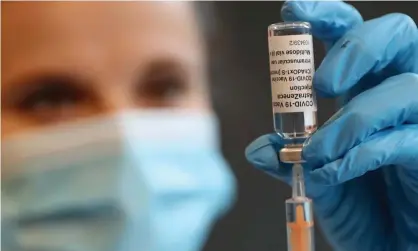  ??  ?? A pharmacist prepares a shot of the Oxford/AstraZenec­a vaccine at Kingston University in London. Photograph: Chris Jackson/Getty