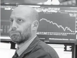  ?? RICHARD DREW/AP ?? Specialist Meric Greenbaum works on the floor of the New York Stock Exchange during Friday’s selloff.