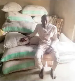  ?? ?? Umar, the 24-year-old farmer with his harvested paddy