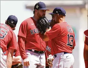  ?? Lynne Sladky / Associated Press ?? Boston Red Sox manager Alex Cora (13) talks with relief pitcher Kaleb Ort during a spring training game against the Pirates on Tuesday in Bradenton, Fla.