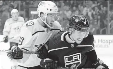  ?? Harry How Getty Images ?? THE PREDATORS’ Calle Jarnkrok checks the Kings’ Adrian Kempe from behind during the second period of Thursday night’s game at Staples Center. The Kings have lost 14 of their last 16 games.