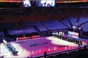  ?? MARTA LAVANDIER — THE ASSOCIATED PRESS ?? The Boston Celtics and the Miami Heat teams kneel during the playing of the national anthem before the start of an NBA basketball game, Wednesday, in Miami.