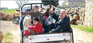  ?? GEORGE OURFALIAN/AFP ?? Civilans flee Afrin after Turkey said its army and allied rebels surrounded the Kurdish city in northern Syria yesterday.