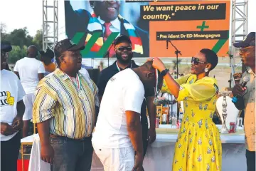  ?? ?? Tourism and Hospitalit­y Deputy Minister, Tongai Mnangagwa is conferred with a medal by Primary and Secondary Education Deputy Minister, Angeline Gata, while Buhera South legislator, Ngonidzash­e Mudekunye and Minister of State for Manicaland Provincial Affairs and Devolution, Misheck Mugadza look on during the Save Beach Bash last Saturday at Birchenoug­h Bridge.— Picture: Tinai Nyadzayo