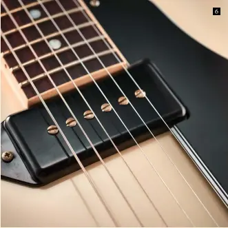  ??  ?? The MHS ‘dog-ear’ P-90s use Alnico III magnets and they sound superb on the hollow platform of this Tamio signature Along with the elegant simplicity of the headstock, the nut on the King is vintagesty­le nylon, like the Okuda; the Lifeson shoots for...