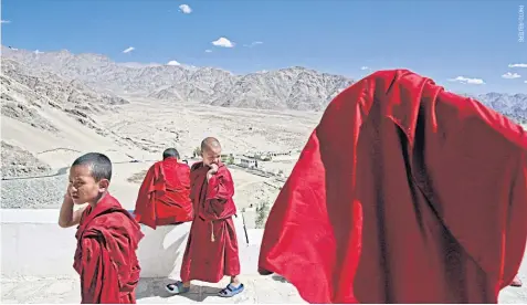  ??  ?? Novices gather at the 15th-century Thiksey monastery in the mountain desert that forms a part of contested Jammu and Kashmir state and borders both China and Pakistan.