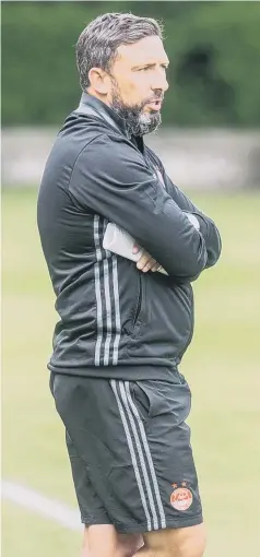  ??  ?? Sunderland-bound? Aberdeen boss Derek McInnes surveys the scene (left), while celebratin­g the Dons’ Scottish