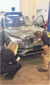  ?? NATIONALTR­ANSPORTATI­ON SAFETYBOAR­D VIAAP ?? Investigat­ors on March 20 examine a driverless Uber SUV that fatally struck a woman in Tempe, Arizona.
