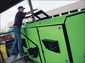  ?? Tyler Sizemore / Hearst Connecticu­t Media ?? EcoRich Sales VP Arthur Henderson demonstrat­es the new composting machine at Katrina Mygatt Recycling Center in Stamford on Tuesday. The new ER-500 composting machine processes up to 500 pounds of composted materials per day, five times more than the ER-100 it is replacing.