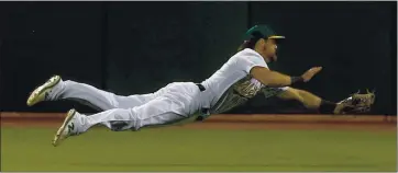  ?? RAY CHAVEZ — STAFF PHOTOGRAPH­ER ?? A’s outfielder Chad Pinder, shown making a diving catch in the fifth inning of Thursday’s opener, has the skills to be an everyday player but the A’s can’t find a spot in the lineup for the versatile utilityman.