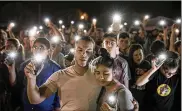  ?? / AUSTIN AMERICAN-STATESMAN VIA AP JAY JANNER ?? Matthew Mata and Erika Gonzalez participat­e in a memorial service for the victims of Sunday’s church shooting in Sutherland Springs, Texas, Monday.