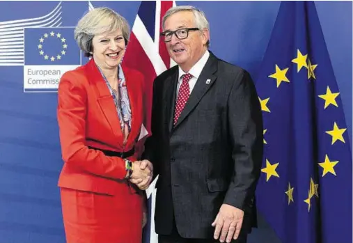  ??  ?? WELCOME: EC President Jean-Claude Juncker greets Theresa May on her arrival at EU headquarte­rs in Brussels yesterday