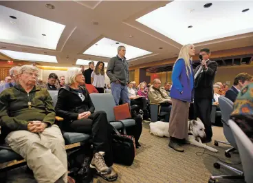  ??  ?? ABOVE: Accompanie­d by her search and rescue dog AkioYodasa­n, Delinda VanneBrigh­tyn, president and K-9 leader of Taos Search and Rescue, addresses the House Environmen­t, Energy and Natural Resources Committee in support of House Bill 366 on Thursday.