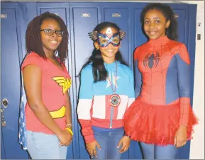  ?? STAFF PHOTOS BY SARA NEWMAN ?? Amaya Mitchell, 12, Olivia McNeil, 11, both of White Plains, and Shamariah Walker, 12, of Waldorf, dress in different superhero outfits Monday as part of Matthew Henson Middle School’s Unity Week. Each day was themed something different to encourage...