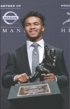  ?? The Associated Press ?? HEISMAN POSE: Oklahoma quarterbac­k Kyler Murray was announced Saturday in New York as this year’s winner of the Heisman Trophy.