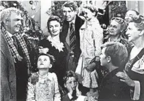  ??  ?? George Bailey (Jimmy Stewart), center, holds Zuzu (6-year-old Karolyn Grimes), in the 1946 Frank Capra classic “It’s a Wonderful Life.”