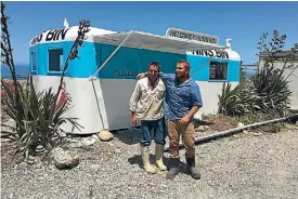  ?? PHOTO: PIPPA BROWN/STUFF ?? Nins Bin has been given a fresh paint in time for State Highway 1 reopening on Friday. Johnny Clark, right, is taking over the business from his father Rodney Clark, left.